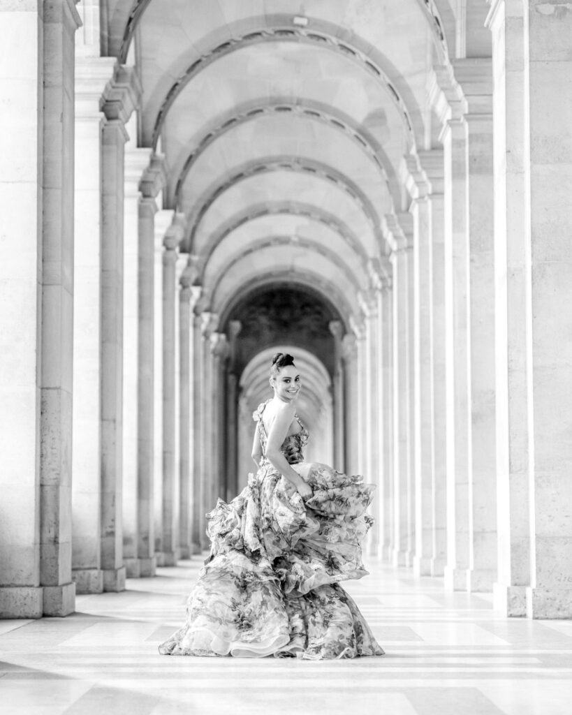 Model spinning her dress in Paris for an editorial shoot